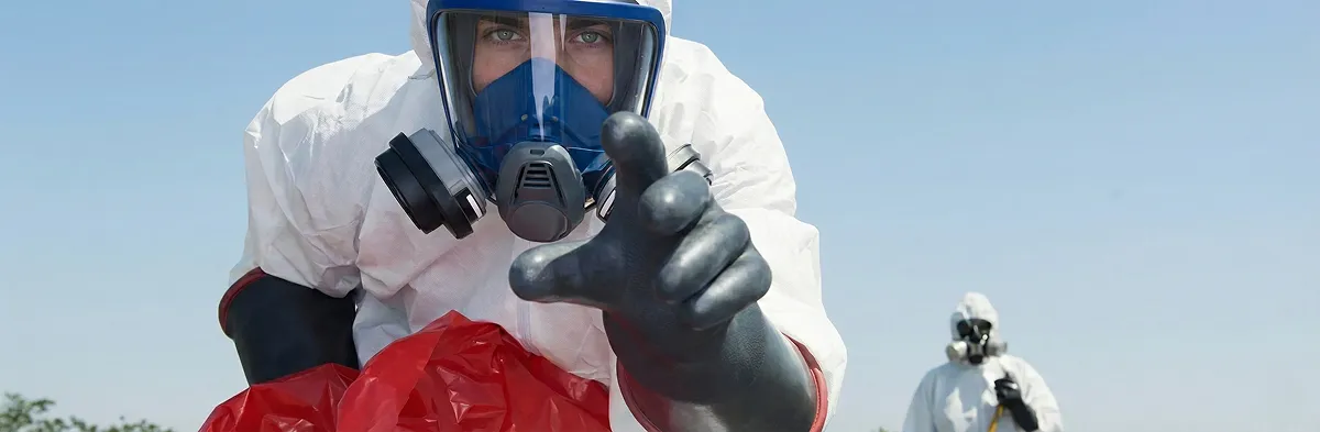 sewage clean up technician wearing protective gear handling biohazard materials in San Francisco, CA